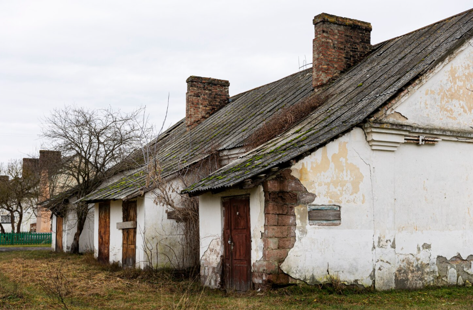 Old brick chimneys on a row house, evoking the hazardous work of child chimney sweeps.